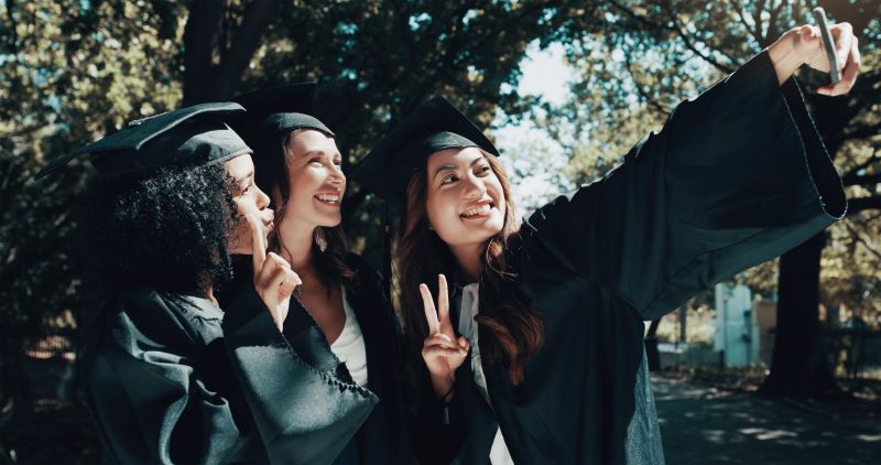 3 graduates smiling for a selfie