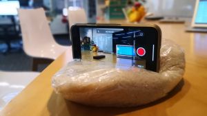 Phone nestled on it's side in a bag of rice, with the camera setting.